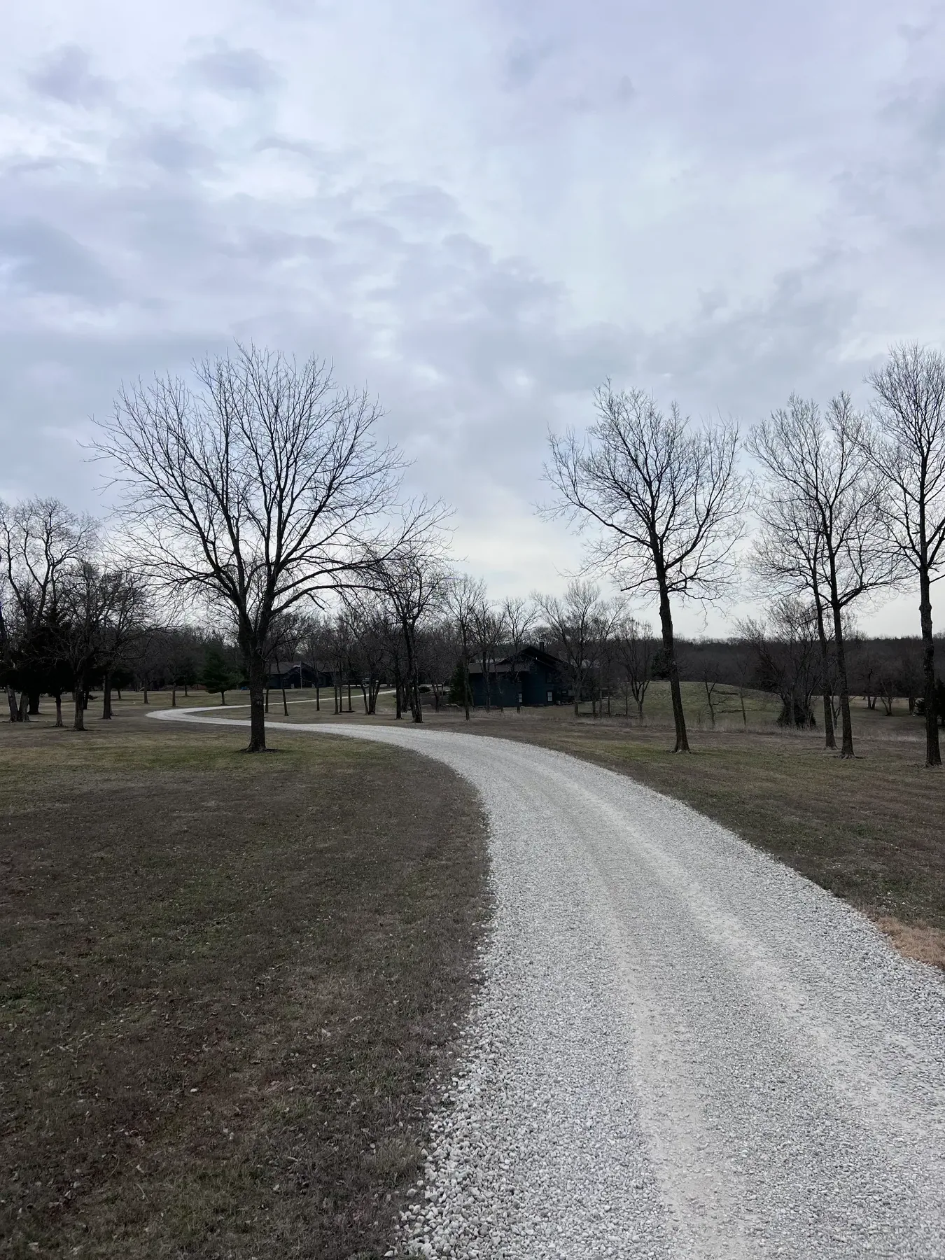 White rock driveway curving through a residential property